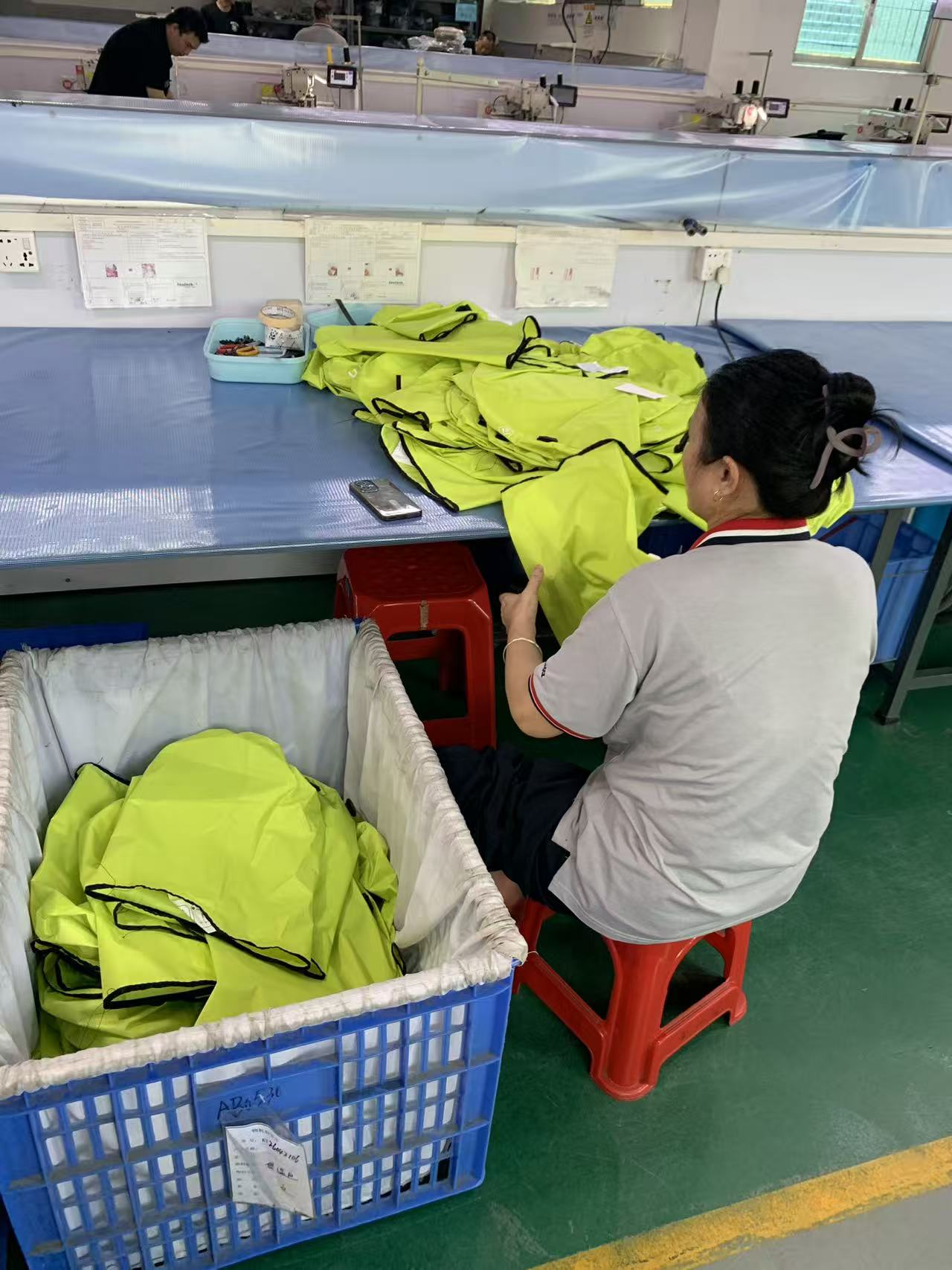 Sewing line running high-visibility yellow dry bags with bound edges